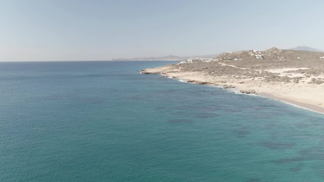 BUZZARDS EAST CAPE LOS CABOS BCS MEXICO-2022: Gentle Waves Lapping Sandy Coastline and Rocky Headland