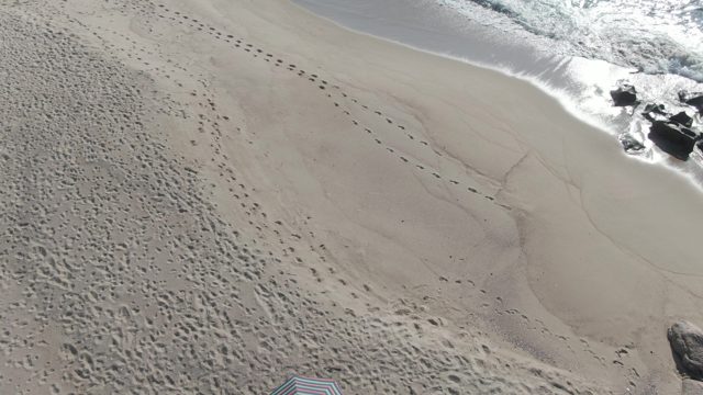 BUZZARDS EAST CAPE LOS CABOS BCS MEXICO-2022: Sandy Beach Footprints and Moving Ocean Waves