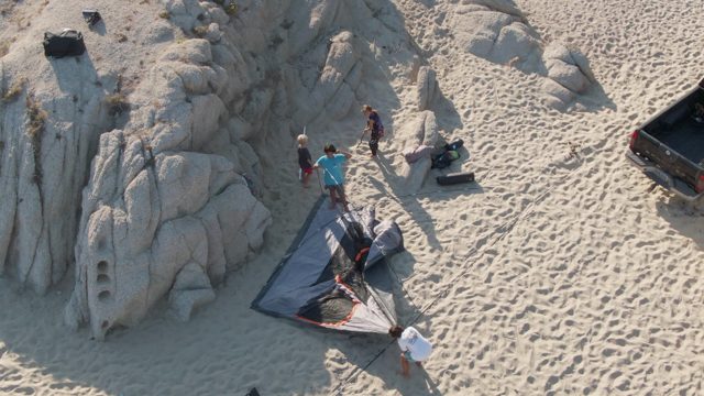 SHIPWRECKS BEACH EAST CAPE LOS CABOS BCS MEXICO-2022: People Setting Up Tent on Sandy Beach