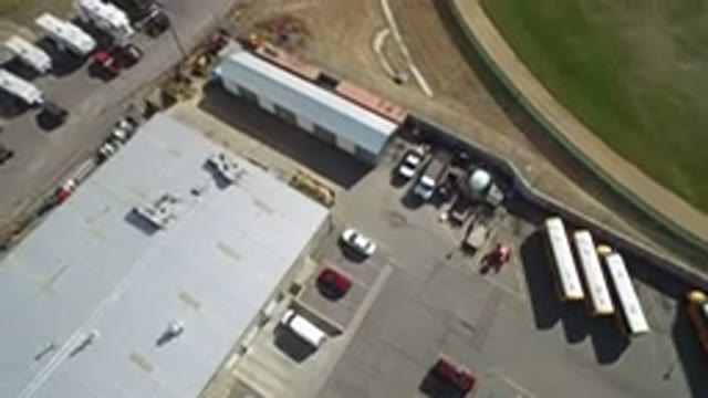 HIDDEN LAKE COLORADO-2016: An Aerial View Of An Industrial Building With Trucks And Vans