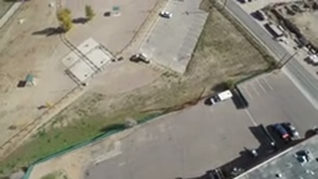 HIDDEN LAKE COLORADO-2016: An Aerial View Of A Dirt Parking Lot And Asphalt