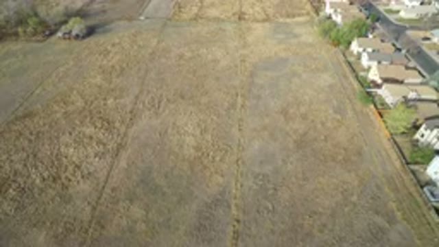 HIDDEN LAKE COLORADO-2016: Drone Flight Above Field Behind Houses On Road