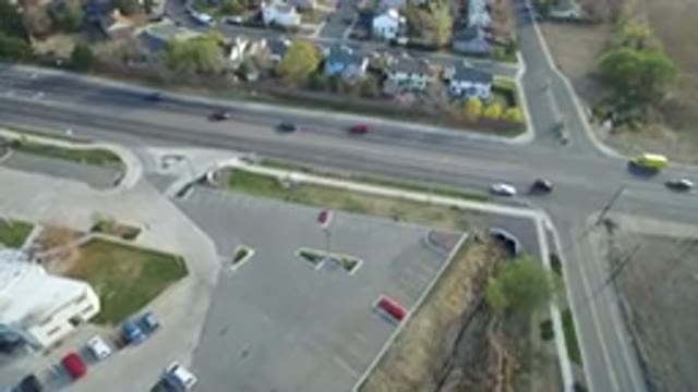 HIDDEN LAKE COLORADO-2016: Busy Traffic Crosses Road Near Houses And Parking