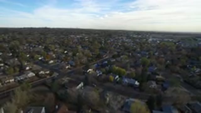 HIDDEN LAKE COLORADO-2016: Drone Flying Calmly And Slowly Across A Suburban Area