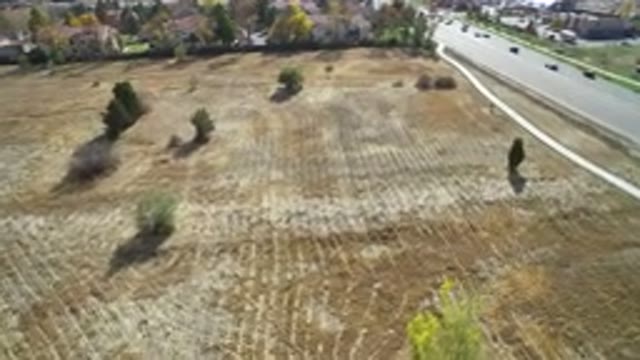 HIDDEN LAKE COLORADO-2016: Drone Flight Over Field With Busy Road On The Right