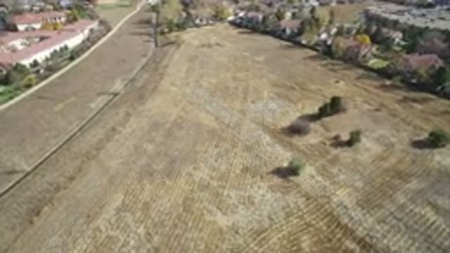 HIDDEN LAKE COLORADO-2016: Brown Field With Homes Next To Farm And Irrigation Ditch