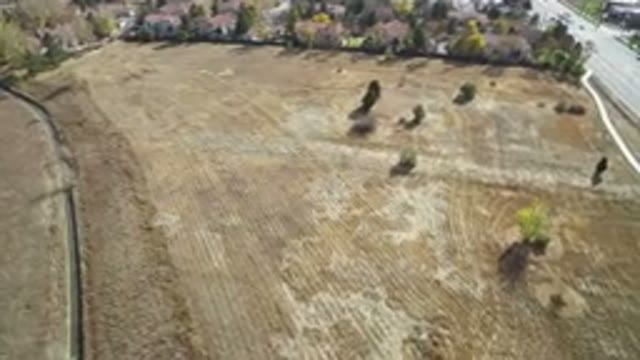 HIDDEN LAKE COLORADO-2016: Overhead Shot of Rural Field with Passing Cars