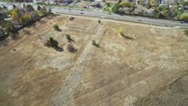 HIDDEN LAKE COLORADO-2016: Aerial Shot Of An Empty Field By A Busy Road