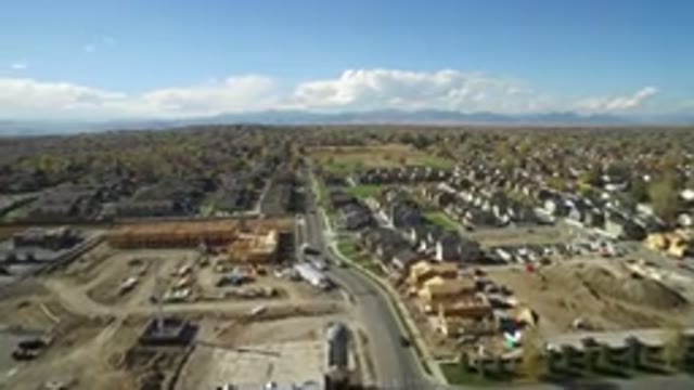 HIDDEN LAKE COLORADO-2016: Drone View Of Town Surrounded By Distant Mountains