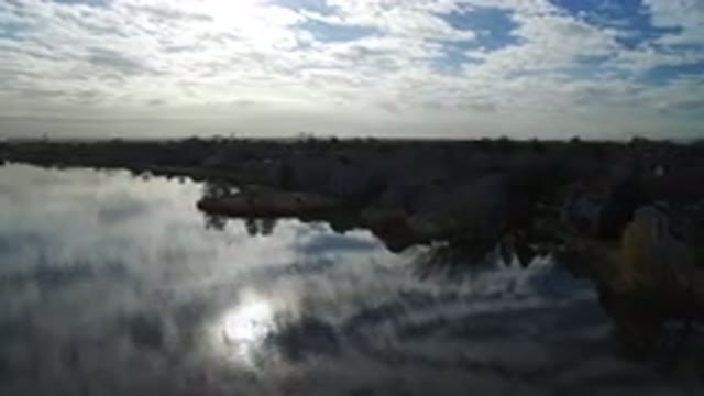 HIDDEN LAKE COLORADO-2016: Aerial View Flying Over Water Approaching Land With