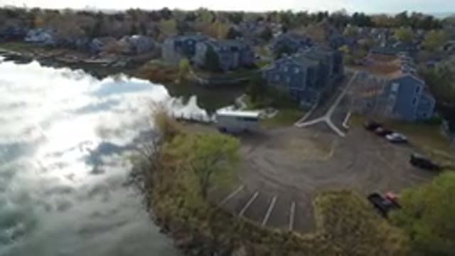 HIDDEN LAKE COLORADO-2016: City Built On The Shore Of A Lake With Calm Water