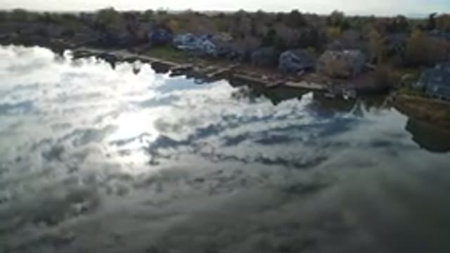 HIDDEN LAKE COLORADO-2016: Drone Flying Showing A Nice Reflection Of The Clouds