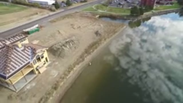 HIDDEN LAKE COLORADO-2016: Panning Bird's-Eye View Of A House On Shore With Road