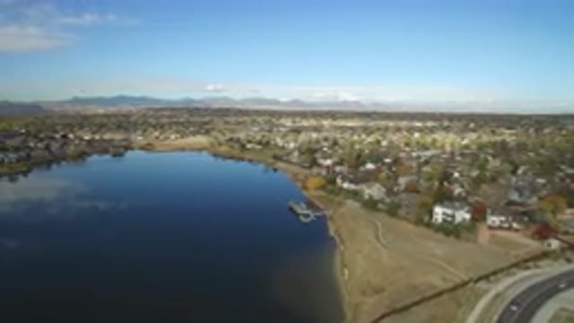 HIDDEN LAKE COLORADO-2016: The View Of A Large Lake That Reflects A Blue Sky