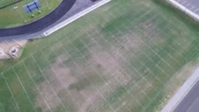 HIDDEN LAKE COLORADO-2016: Aerial View Of A Green Football Field Surrounded By A