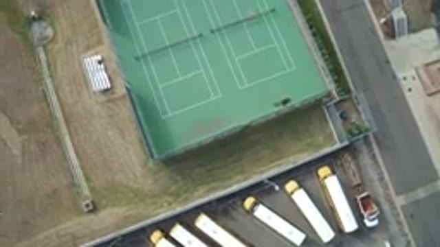 HIDDEN LAKE COLORADO-2016: Aerial View of Two Green Tennis Courts Beside a Street