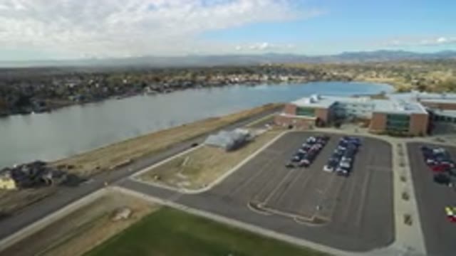 HIDDEN LAKE COLORADO-2016: Parking Lot With Cars In Front Of Warehouse Next To