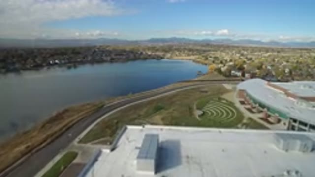 HIDDEN LAKE COLORADO-2016: Camera Zooming Over Office Buildings By A Highway And Mountains