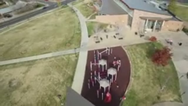 HIDDEN LAKE COLORADO-2016: Air Filming A Yellow Building With A Grey Roof And A Playground