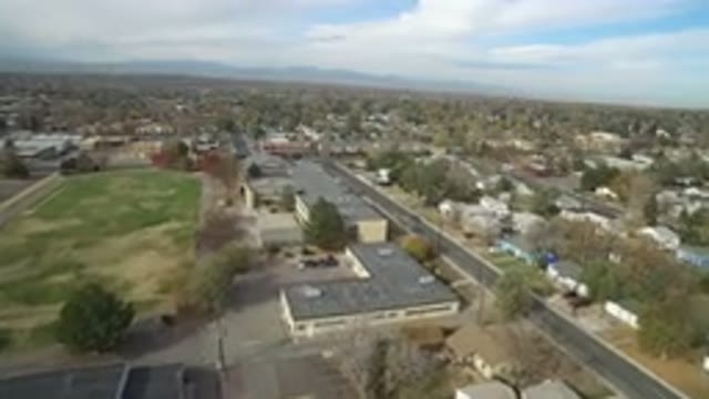 HIDDEN LAKE COLORADO-2016: The Empty Schoolyard With A Large Grassy Field With Trees
