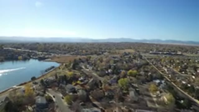 HIDDEN LAKE COLORADO-2016: Pilot Flying Over Suburban Area On A Clear Blue Sky