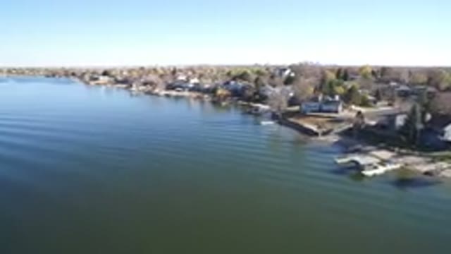 HIDDEN LAKE COLORADO-2016: Moving Shot Of Lakeside Buildings Some With Moorings