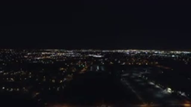 DENVER COLORADO-2016: Night Time Aerial Shot of City with Lights Fading Into Distance