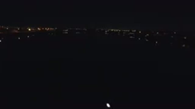 DENVER COLORADO-2016: A Vessel Moves Down A River At Night With Lights From
