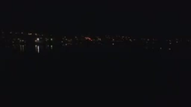 DENVER COLORADO-2016: Night View Of A Coast Lights Reflecting On The Sea