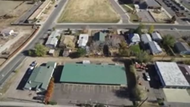 WESTMINSTER COLORADO-2016: Drone Shot Of Long Green Roofed Building With Houses