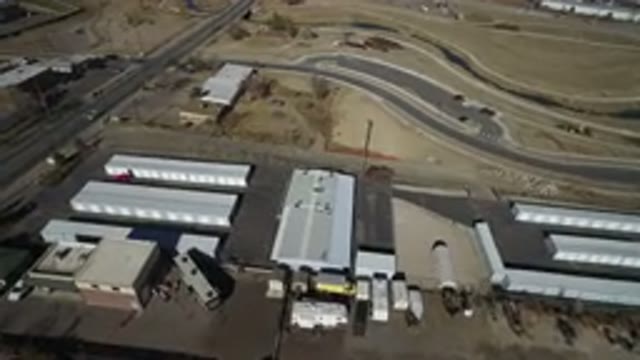 WESTMINSTER COLORADO-2016: Aerial View of Desert Highway with Parked Cars and Rectangular Buildings
