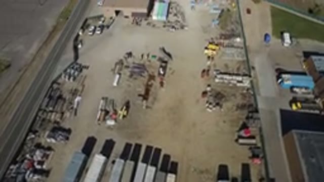 WESTMINSTER COLORADO-2016: Sandy Lot With Parked Vehicles and Industrial Structures
