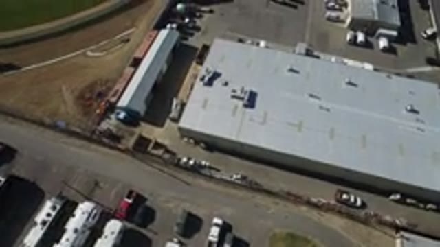 WESTMINSTER COLORADO-2016: Industrial Building Parking Lot With Trucks And Buses