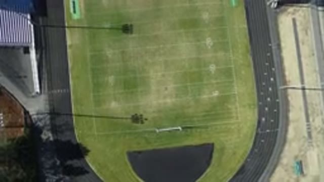 WESTMINSTER COLORADO-2016: Daytime Empty Sports Field with Green Grass and Gray Track