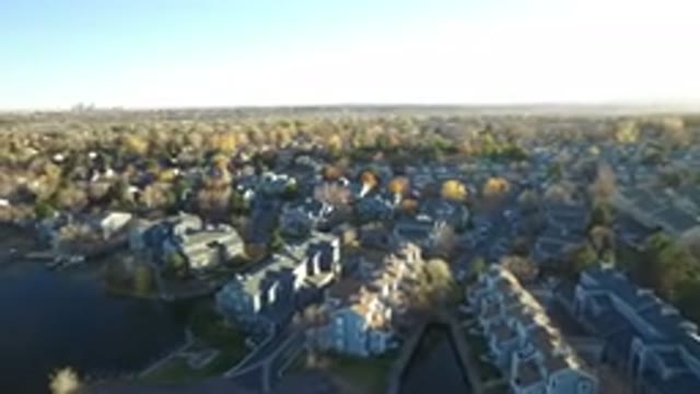 WESTMINSTER COLORADO-2016: Plane Flying Above A Lake With A Town On The Other Side