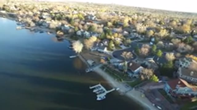 WESTMINSTER COLORADO-2016: Drone Shot Of Buildings And Trees By A Lake With