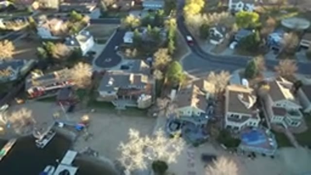 WESTMINSTER COLORADO-2016: A Car Passing On The Road And Many Houses Trees