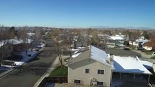 HIDDEN LAKE COLORADO-2016: Drone Descending Over Snow-Covered Rooftops in Winter Neighborhood