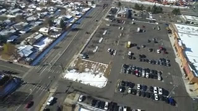 HIDDEN LAKE COLORADO-2016: Parking Lot Filled With Cars Next To Trees Next To Buildings