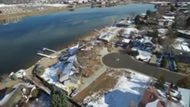 HIDDEN LAKE COLORADO-2016: Homes Arranged Around A Lake With Areas Of Snow