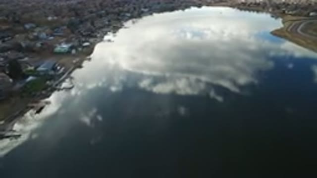 WESTMINSTER COLORADO-2016: Sky Reflected In A Body Of Water Surrounded By Homes