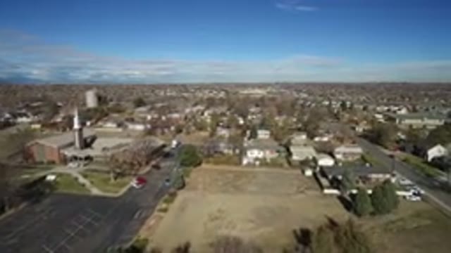 WESTMINSTER COLORADO-2016: Plane Flying Over Brown Land in Aerial View