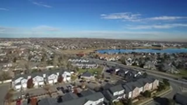 WESTMINSTER COLORADO-2016: Plane Flying Over a Winding Road with Houses Above