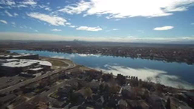WESTMINSTER COLORADO-2016: Houses Flanking A Body Of Water With City Landscape