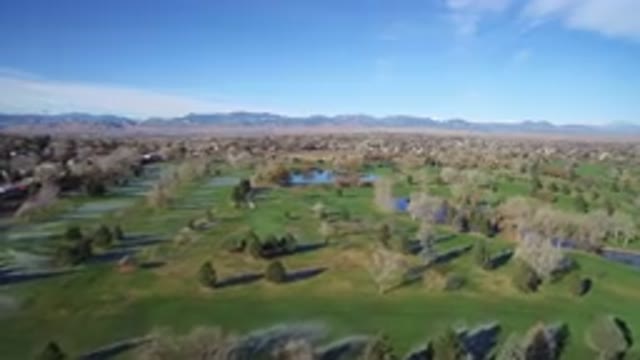 WESTMINSTER COLORADO-2016: Flying Over A Field With Trees, River And Mountains