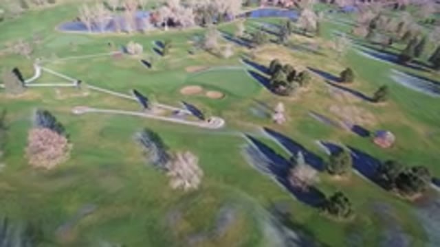 WESTMINSTER COLORADO-2016: A Large Empty Golf Course With Trees And A Small Lake