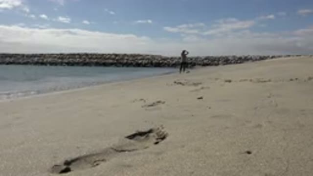 SAN JOSE DEL CABO MEXICO-2017: Person Running Their Hands Through Their Hair At Shore