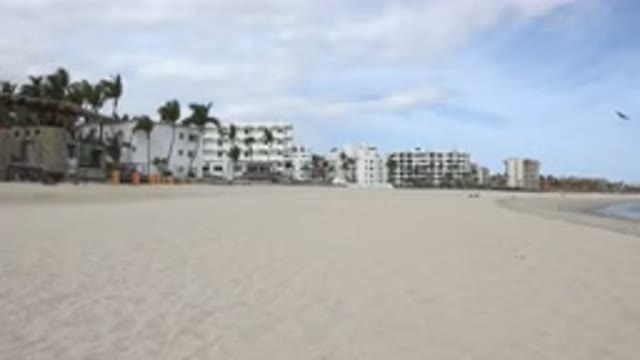 SAN JOSE DEL CABO MEXICO-2017: A Virtually Empty Beach Lined With Buildings