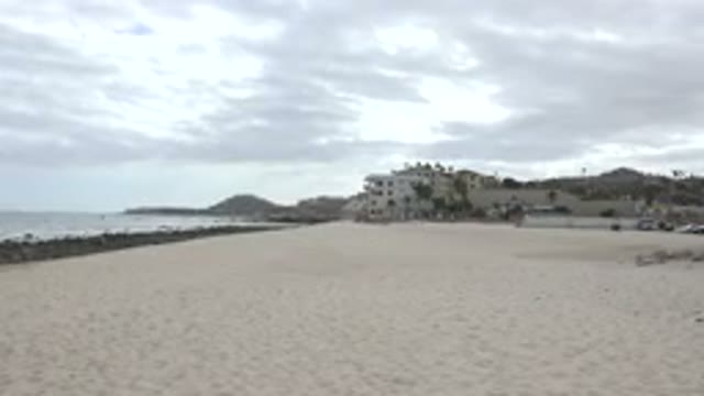 SAN JOSE DEL CABO MEXICO-2017: Cloud Day Beach Deserted Near Sea With Building