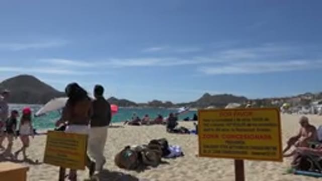 CABO SAN LUCAS MEXICO-2017: People Walking On A White Sand Beach With Many